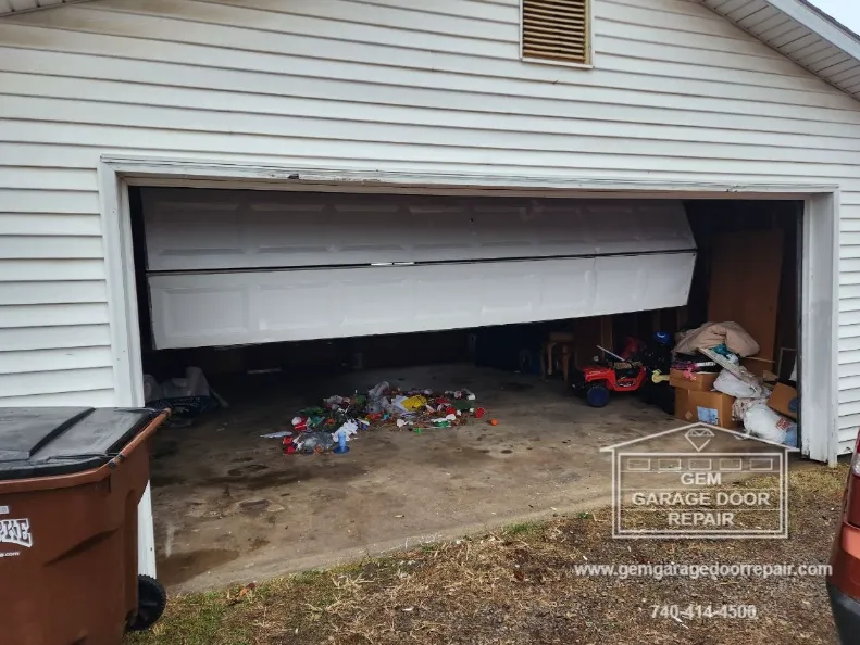 This garage door fell right out of its tracks after an accident while closing the door.
