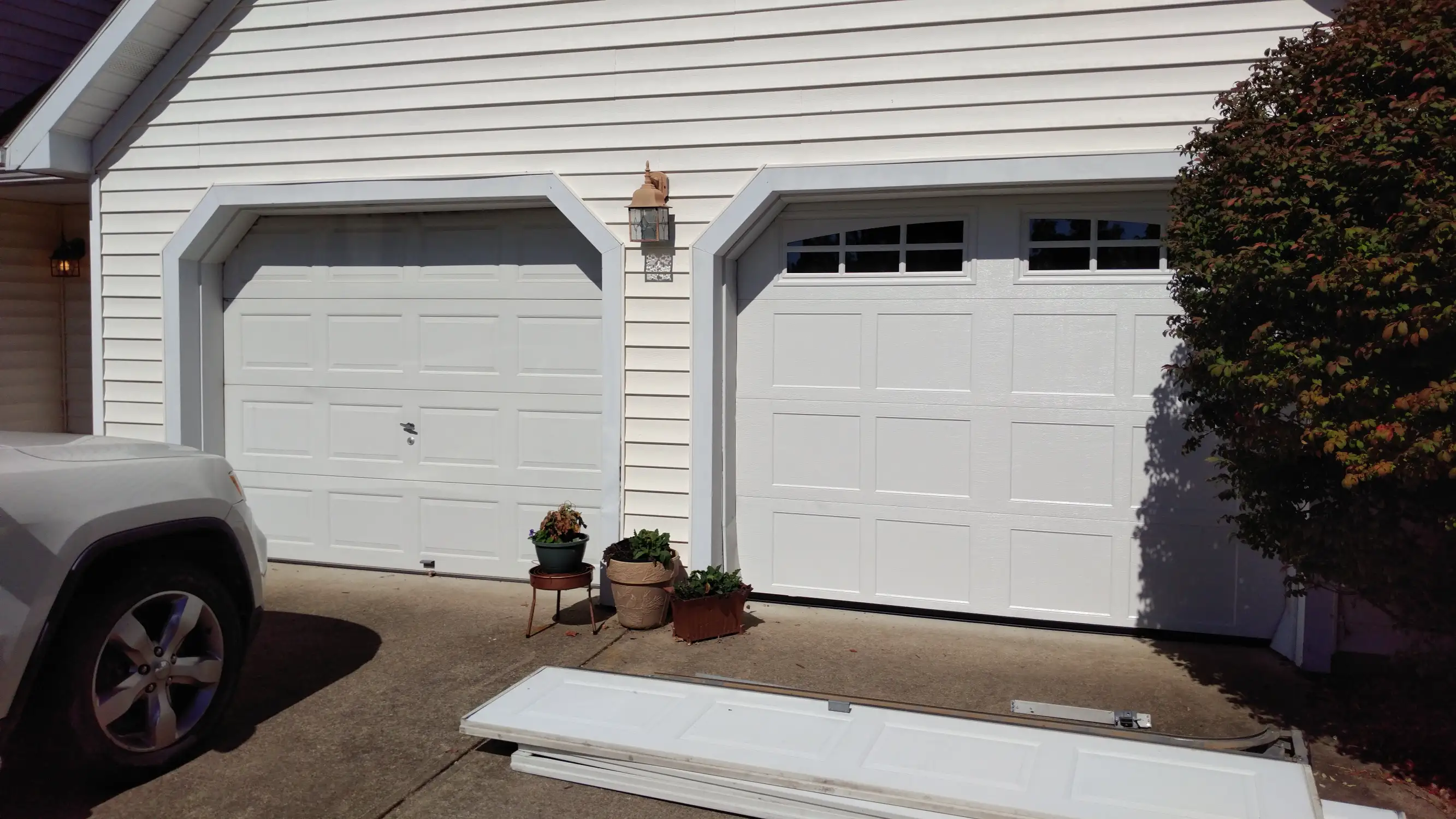 Half and Half. One old garage door still on while the other is just getting finished.