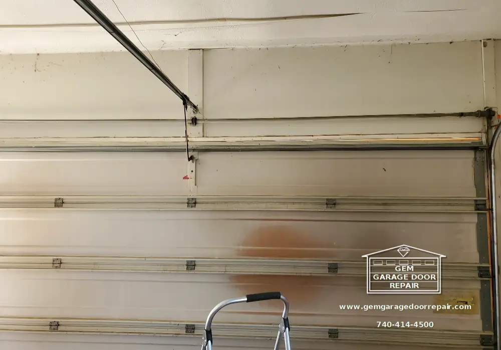 Before - Broken spring hidden inside the tube above the door