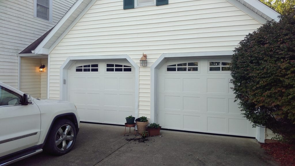 A pair of carriage style garage doors with windows.