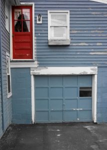 Old garage door with mystery door